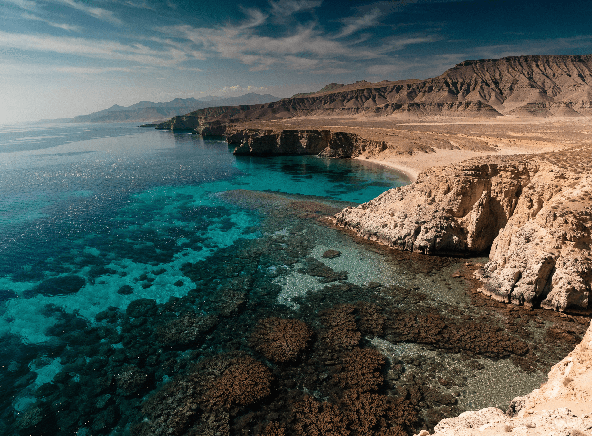Turquoise Red Sea coastline in Egypt with a coral reef visible beneath the surface