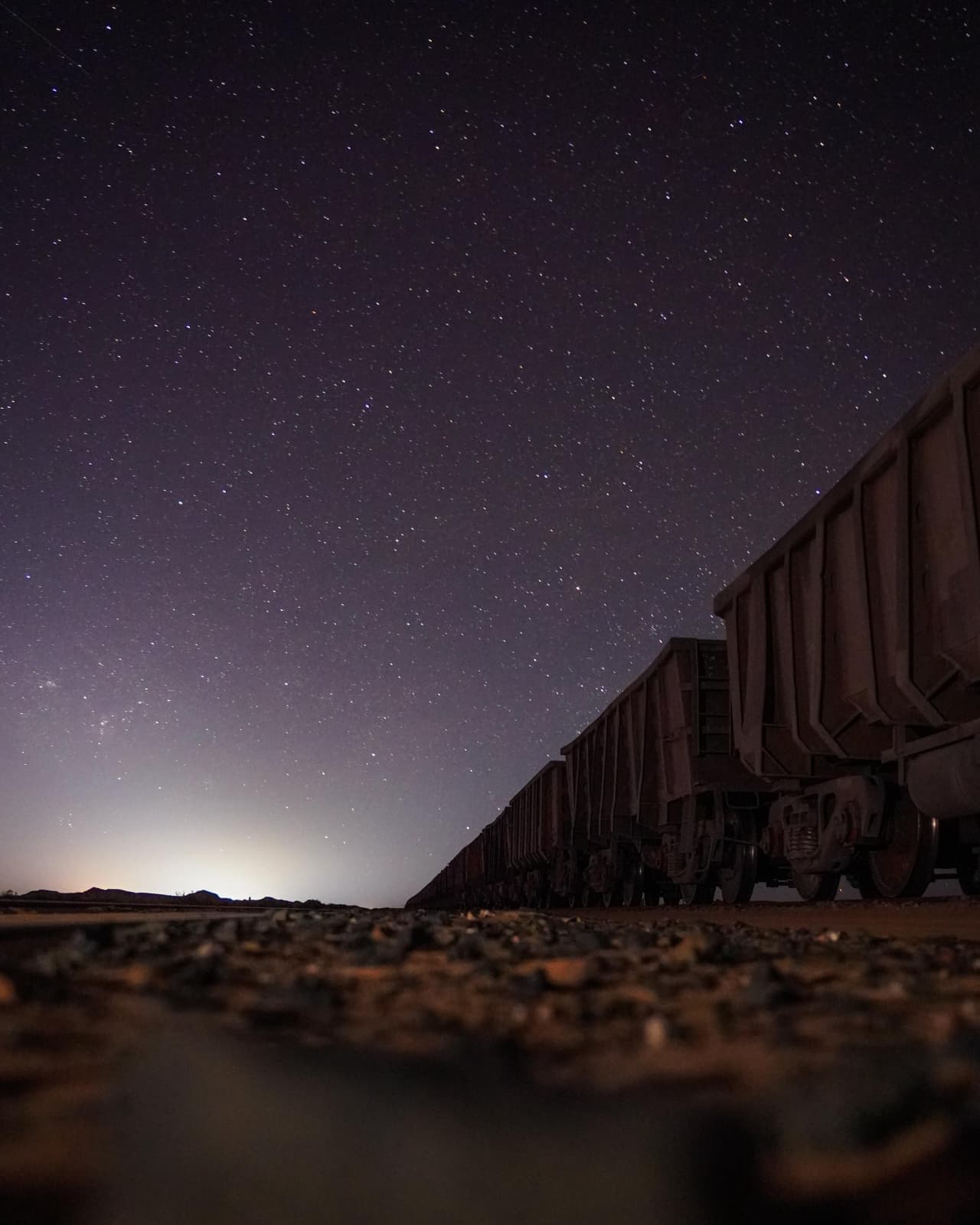 Mauritania's iron ore train stretching across the desert under a star-filled night sky